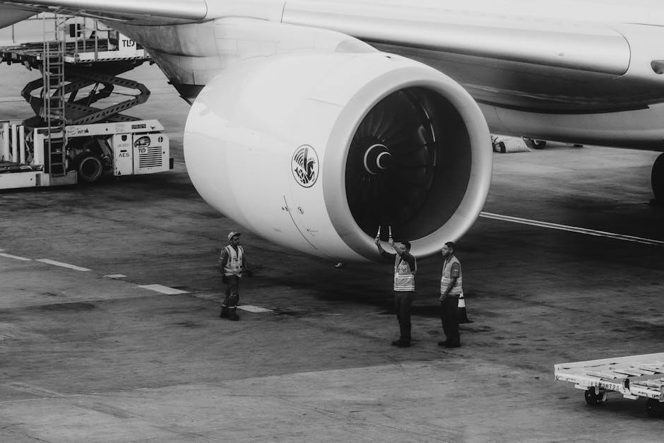 Aviation workers inspecting jet engine